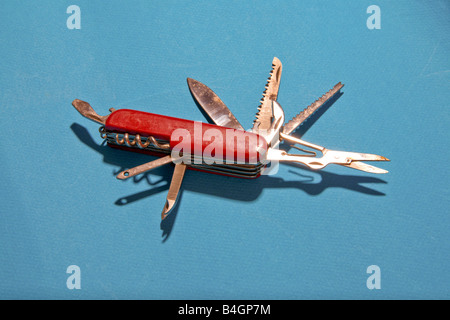 Open Swiss army knife shows variety of blades. Stock Photo