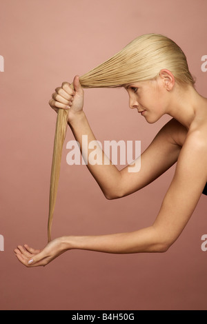 Side profile of young woman washing her hair Stock Photo
