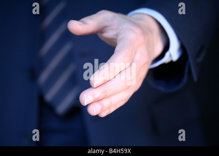 Mid section view of businessman reaching for hand shake Stock Photo