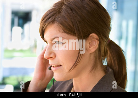 Close-up of businesswoman talking on headset Stock Photo