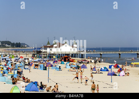 Tourists on beach with pier in background Ahlbeck Usedom Mecklenburg-West Pomerania Germany