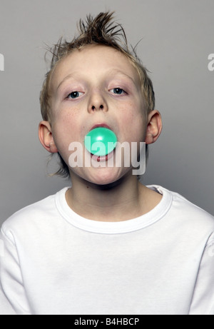 Portrait of boy blowing chewing gum Stock Photo