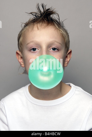 Portrait of boy blowing chewing gum Stock Photo