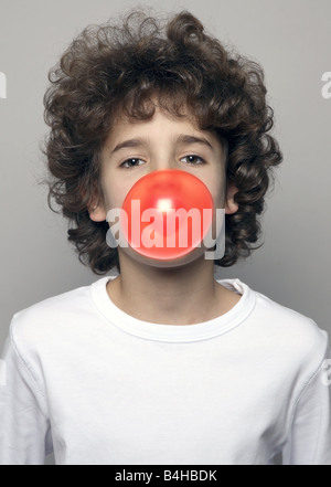 Portrait of boy blowing chewing gum Stock Photo