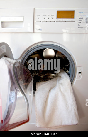 Close-up of towel coming out from washing machine Stock Photo