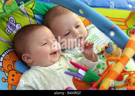 Two baby boys twin brothers playing together Stock Photo