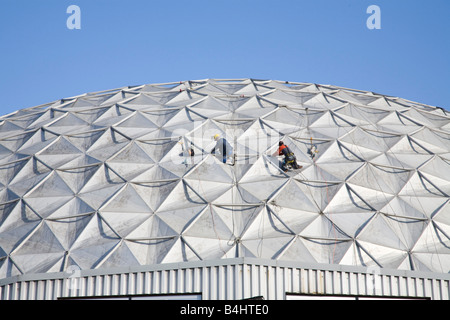 Men working on the roof on at Porte de Versailles, Paris Stock Photo