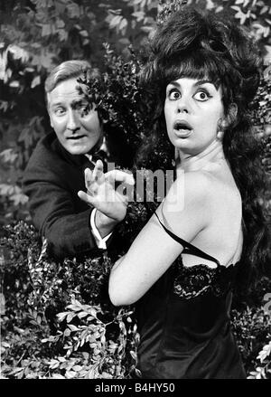 Leslie Phillips actor with actress Catherine Feller in one of the scenes from the film Doctor In Clover Stock Photo