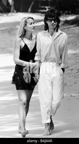 Jerry Hall model and actress walks arm in arm with her boyfriend Rolling Stones Mick Jagger in Barbados March 1981 Dbase MSI Stock Photo