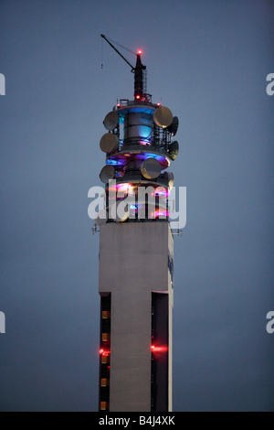 Communications devices lit up at night on top of the BT Tower in Birmingham UK Stock Photo