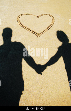 couple holding hands on the beach Stock Photo