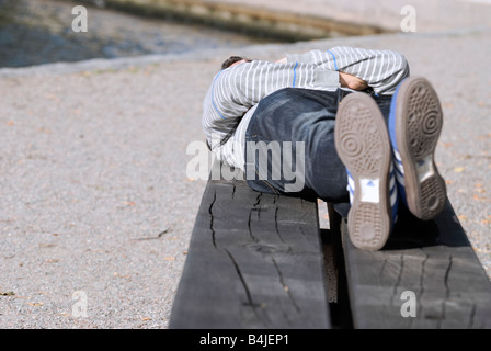 A young man overlays the bench Stock Photo