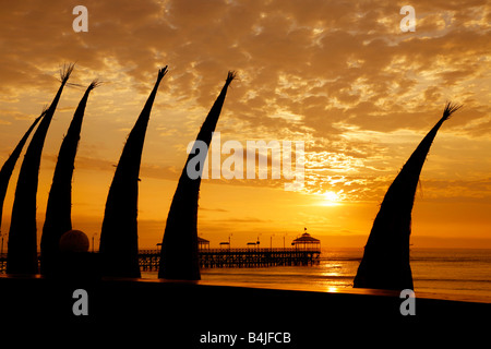 Reed boats drying out on the beachfront in Huanchaco,Peru Stock Photo