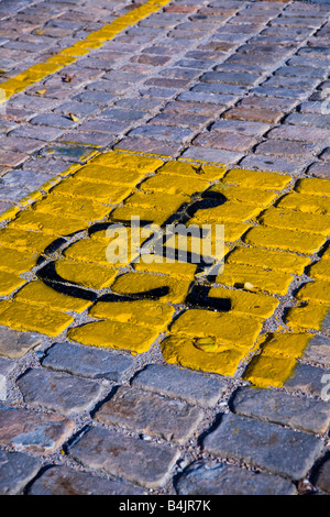 Wheelchair parking space symbol on cobblestone. Stock Photo