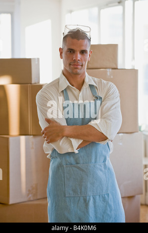 Hispanic man wearing apron and protective eyewear Stock Photo