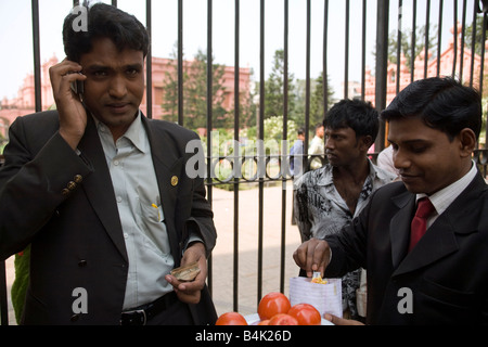 A man in a business suit talks on his cell phone in Dhaka Bangladesh Stock Photo