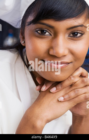 Close up of Mixed Race female pastry chef Stock Photo