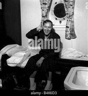 Bill Haley on his first visit to England which was largely sponsored by the Daily Mirror Bill waking up on the ship that he came to England on after docking at Southampton Stock Photo