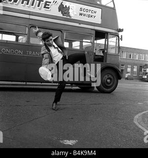 Cliff Richard prepares for his ne role in Summer Holiday by taking control of a 7 5 ton red bus at Chiswich London Transport driving school 07 05 62 Q3930 y2k The plot A double decker tour bus on a trip to Athens collides with a car carrying three female musicians Later the bus picks up a winsome young boy Lauri Peters who turns out to be an incognito American songstress Barbara who is trying to hide out from her overbearing mother and overzealous agent The bus doesn t go too far before she and the bus mechanic Don Cliff Richard fall in love Many musical interludes spice up this romantic tale Stock Photo