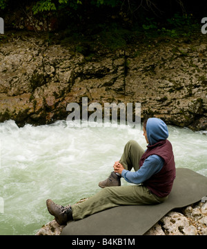 tourist girl sitting on the bank of a mountain river Stock Photo - Alamy