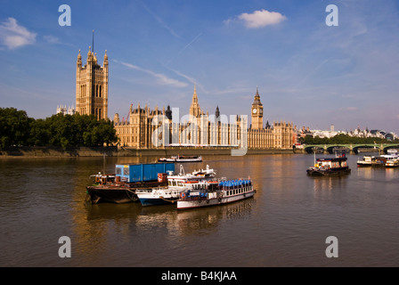 Boats moored on river thames outside houses of parliament, London uk Stock Photo