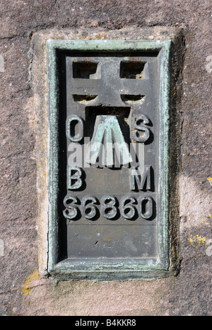 Cast copper Ordnance Survey benchmark. Church of Saint Oswald, Ravenstonedale, Cumbria, England, United Kingdom, Europe. Stock Photo