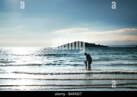 father and daughter playing in the waves Stock Photo