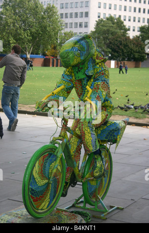 Street Entertainer, Chameleon on a Bicycle, South Bank, London, UK Stock Photo