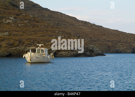 A Small Greek Fishing Boat Lies at Anchor in the Bay of Apokiosis Isle of Kithnos Aegean Sea Cyclades Islands Greece Stock Photo