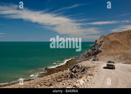 Pickup truck on dirt road at Sea of Cortez coastline south of Puertecitos Baja California Mexico Stock Photo