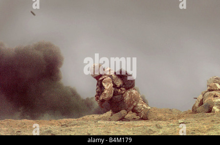 Gulf War British Army 1991 The only photographs showing ground troops in action 10 years ago in the Iraqi desert during the action to liberate Kuwait Mike Moore photographed Private Thomas Gow as he lies in the sand facing enemy fire from a buried personnel carrier Under fire Gow jumps up and runs forward across the mine strewn no mans land Crouching down Gow throws a grenade and destroys the enemy vehicle allowing the advance to continue Private Gow was awarded the Military Medal by the Queen for his bravery that morning Stock Photo