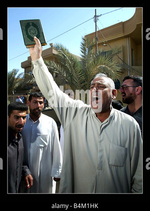 Iraq War April 2003 American soldiers massacre for the second time in 3 days in the town of Al Fallujah approx 50 kilometers north west of Baghdad American soldiers opened fire in descriminately on a demonstration against their massacre on Monday night at the school While the demo was outside the Americans base soldiers sprayed the crowd with bullets killing it is believed at least two people and injuring many more Khalid Abu Walid father of Walid who was shot and killed by American soldiers The Al Ka ahd school on Monday night swears on The Holy Koran that his house was looted by American Stock Photo