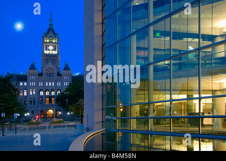 Full moon over the imposing facade of the Salt Lake City and County Building juxtaposed against the modern Main Library Stock Photo