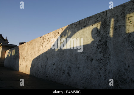one car shadow on wall in city with blue sky Stock Photo