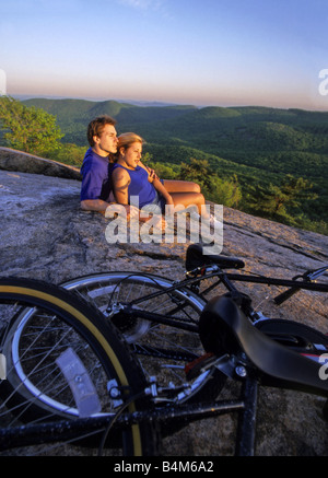 Young couple with bicycles on the mountain top Stock Photo