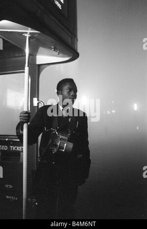 Weather London Smog December 1962 A London Transport bus conductor looks out from the platform of his Routemaster bus during the London Smogs of December 1962 Stock Photo