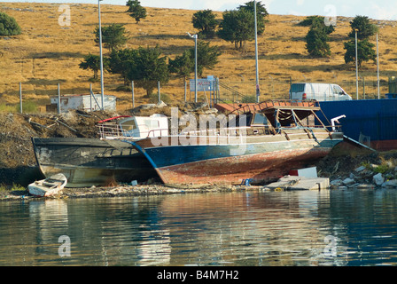 Old Fishing Boats Laid to Rest in Lavrion Harbour in Mainland Greece Bathed in Early Morning Sunshine Stock Photo