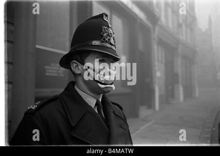 Policeman in smog mask December 1962 PC John Finn from Snow Hill Police Station in the London smog of 1962 He is wear a mask to Stock Photo