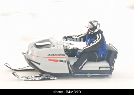 Vintage snowmobiles parade at the I 500 Snowmobile race in Sault Ste Marie Michigan Stock Photo