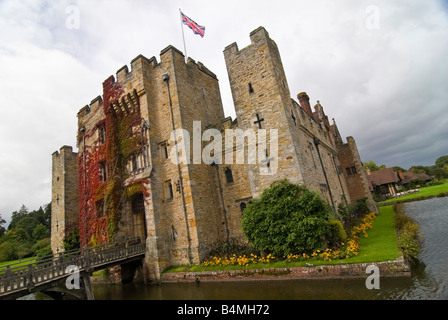 Horizontal wide angle of the front exterior of Hever Castle with the gatehouse and drawbridge crossing the surrounding moat. Stock Photo