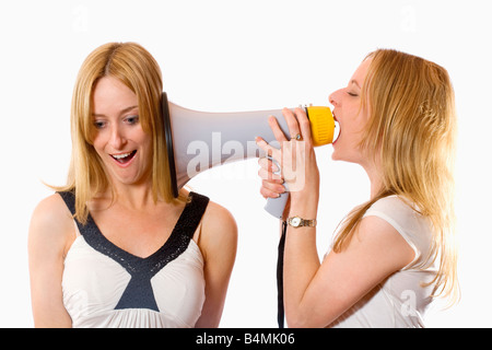 TWIN SISTERS WITH MEGAPHONE Stock Photo