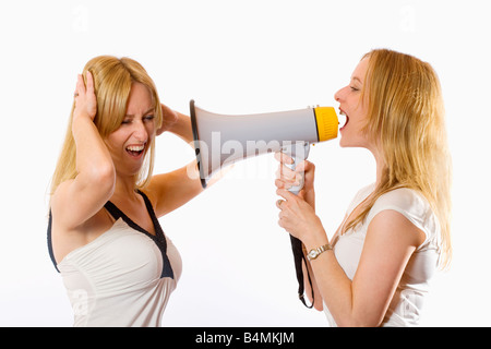 TWIN SISTERS WITH MEGAPHONE Stock Photo
