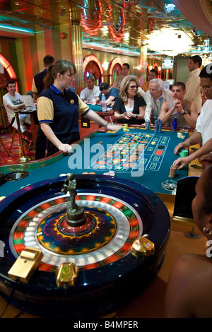 Gamblers playing roulette in casino on Royal Caribbean Navigator of the Seas cruise ship Stock Photo