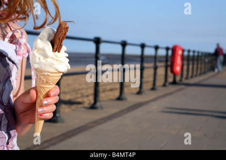 Girl Holding Ice cream at the seaside at Cleethorpes Humberside Lincolnshire Stock Photo