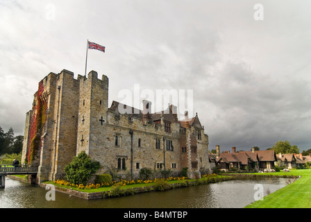 Horizontal wide angle of the front exterior of Hever Castle with the gatehouse and drawbridge crossing the surrounding moat. Stock Photo