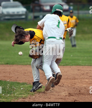 Two High School Baseball players collide during a play near second base Stock Photo