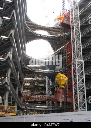 An office block under construction in the More London development, including a hopper suspended from a tower crane, London Stock Photo