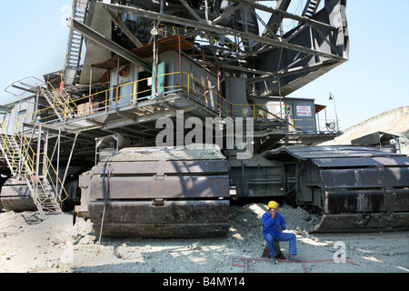 Maritsa Iztok is the largest coalmine in Bulgaria The coals are located 60 meter underground and the layer of coal is around 20 meter The coals are used for generating electricity by burning them The coalmine provides 85 of the country s energy The US is the biggest stakeholder of this company Many large excavators up to 70 meter high are working day and night Stock Photo