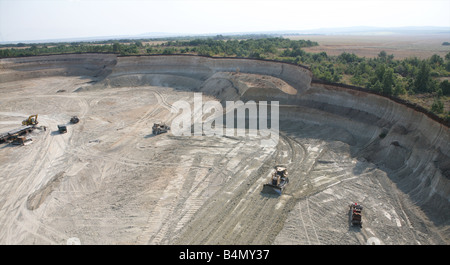 Maritsa Iztok is the largest coalmine in Bulgaria The coals are located 60 meter underground and the layer of coal is around 20 meter The coals are used for generating electricity by burning them The coalmine provides 85 of the country s energy The US is the biggest stakeholder of this company Many large excavators up to 70 meter high are working day and night Stock Photo