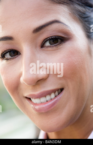 Woman's smiling face outdoors (selective focus) Stock Photo